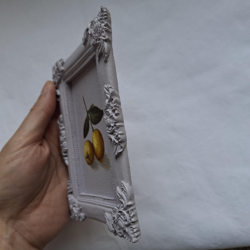 Lemons in a plaster frame