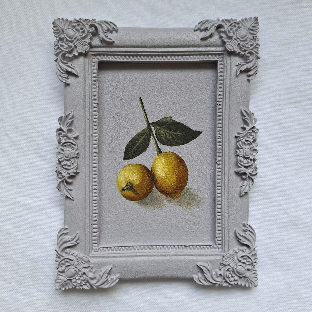 Lemons in a plaster frame