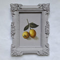 Lemons in a plaster frame